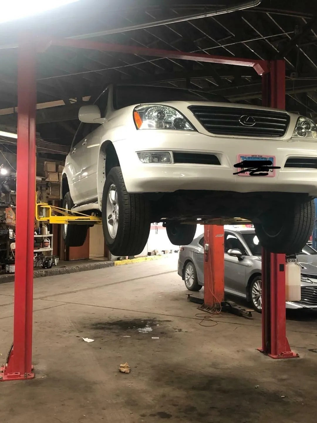 NEW 2 Post Overhead 12000 Lbs Automatic Release Mechanic Lift hoist + Handlejack Close-Up of 2 Post Car Lift Hydraulic System
