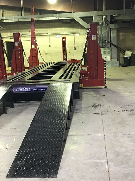 Close-up of the truck frame being straightened using the machine.