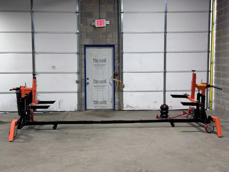 Heavy-duty car rotisserie in workshop
