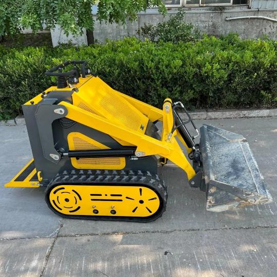 Mini skid steer loaded with dirt demonstrating its capacity.
