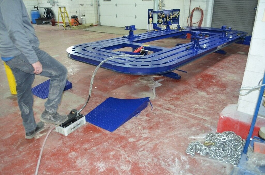 Wheel stands for added stability during auto frame repairs
