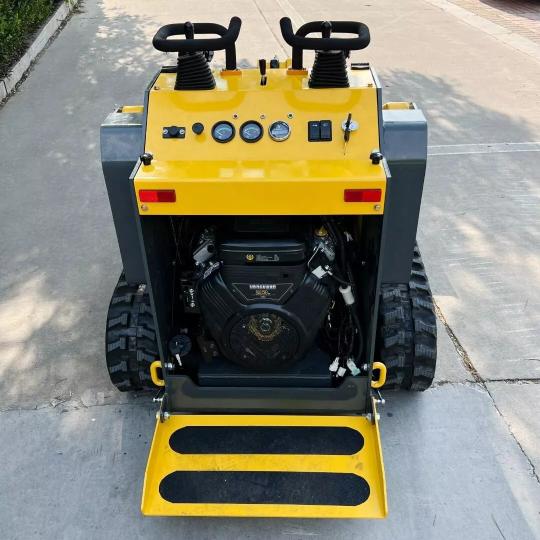 Mini skid steer showcasing its track system.
